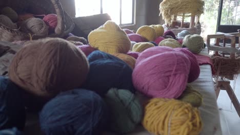 Slow-push-in-shot-revealing-various-colours-of-balls-of-yarn