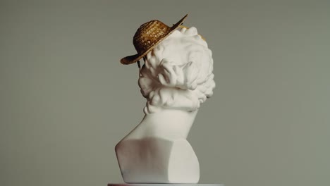 antique bust with straw hat