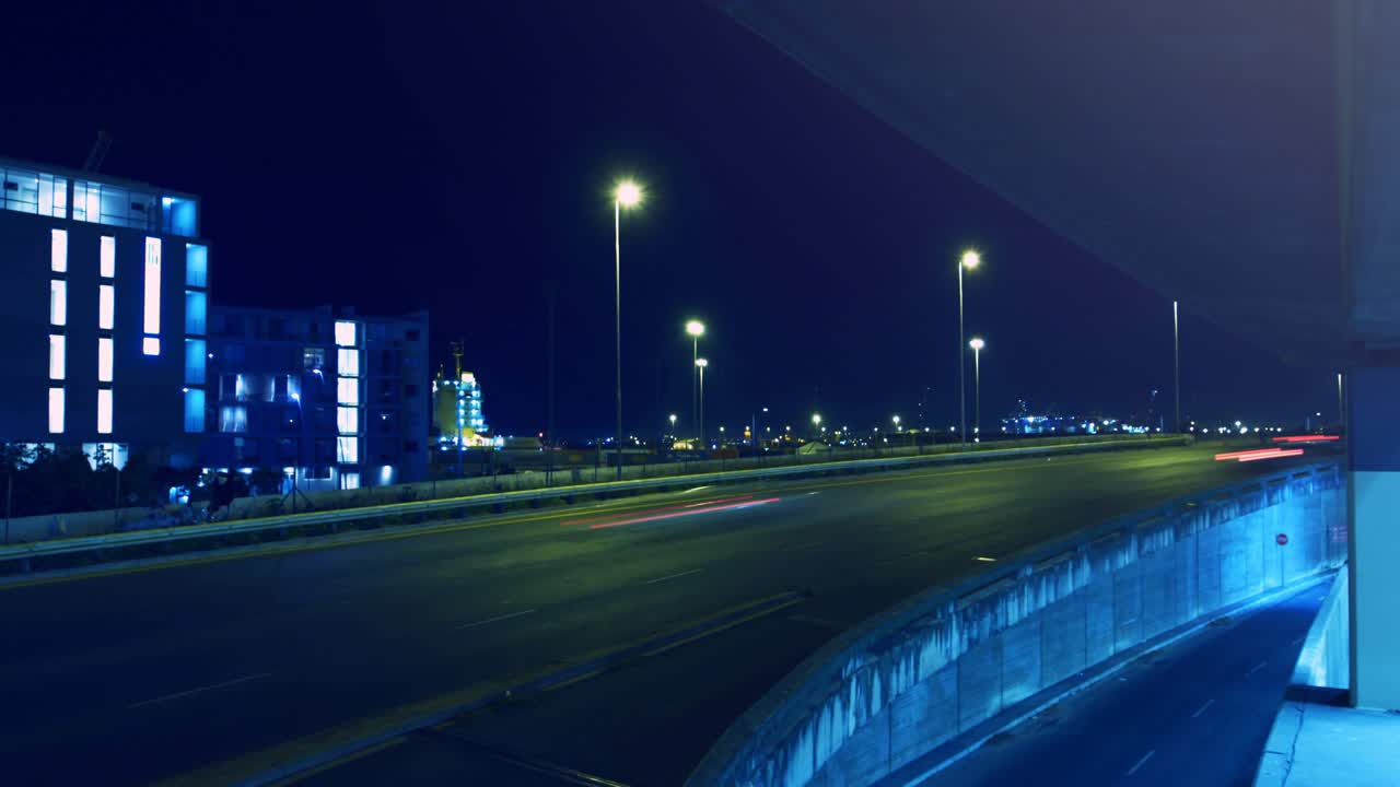 Long-exposure trails starting as highway streaking and bokeh discs growing, showing traffic flow