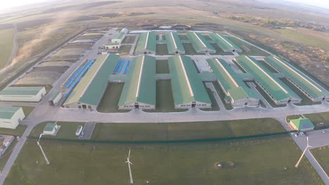 flying over the farm facilities at sunset
