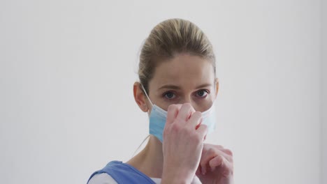 Female-health-worker-wearing-face-mask-at-home