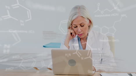 Animation-of-medical-data-processing-over-stressed-caucasian-female-doctor-using-laptop-at-hospital