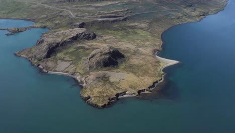 holmanes peninsula with blue water of reyðarfjörður fjord in iceland, aerial