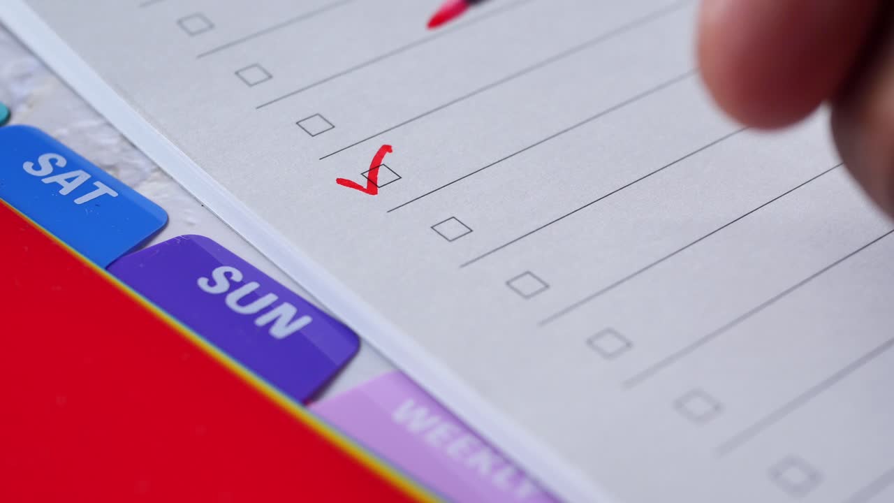 Checking tasks on a weekly planner