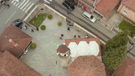 aerial view over european mosque city building and tower, people outside