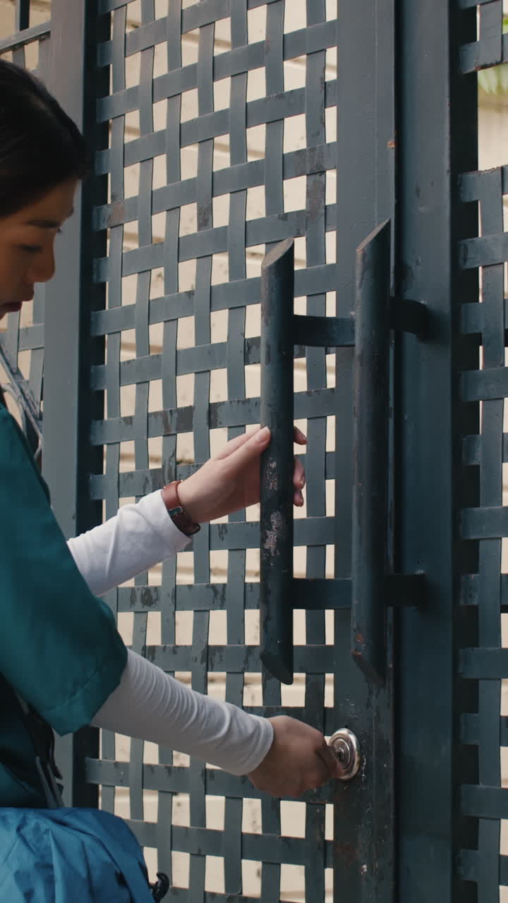 Healthcare Worker Closing Gate Door Leaving for Work