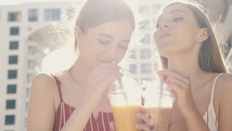 two friends enjoying drinks outdoors in the city