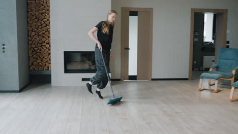 teenage girl mopping a living room floor