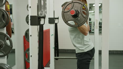 man train on sports training equipment in a fitness gym