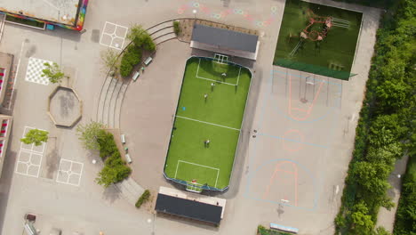 tiny green football field in school yard in solna, stockholm