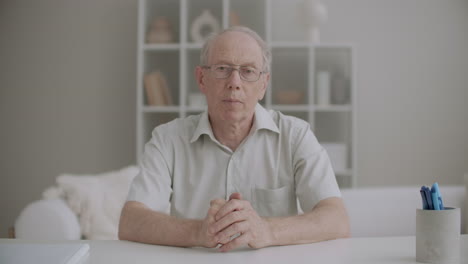 retiree man is greeting and talking distantly by online chat medium portrait at living room communicating by internet