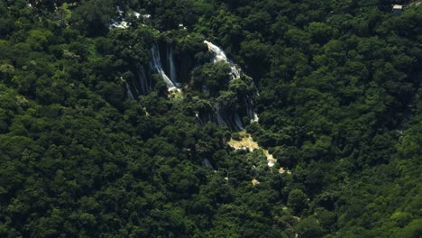 Aerial-view-around-a-waterfall-in-the-mountains-near-Taxco-Guerrero,-Mexico---circling,-drone-shot