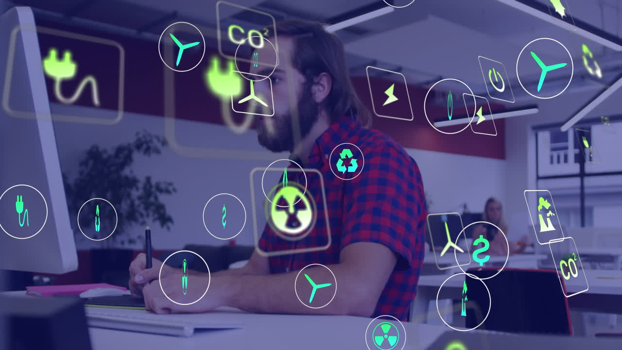 Animation of ecology icons over caucasian businessman using computer