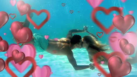 pareja feliz besándose bajo el agua con corazones para el día de san valentín
