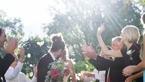 guests toss petals while bride and groom kissing 4k 4k