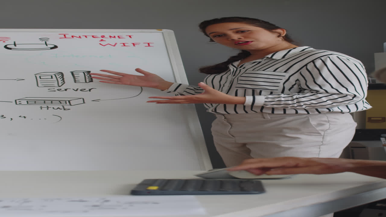 Elderly Woman Listening to Teacher Talking about Computers