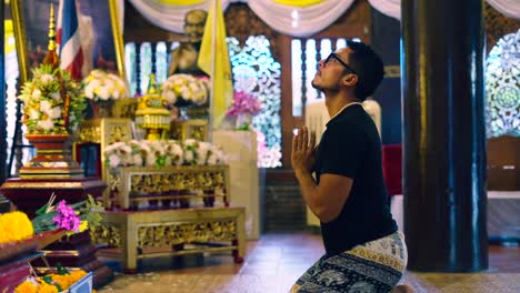 man praying in a thai temple