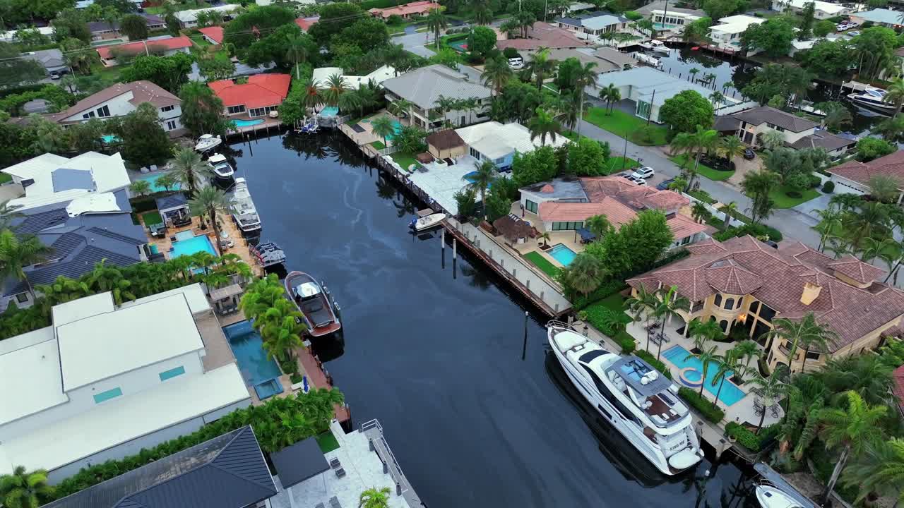 Aerial view of luxury waterfront homes with boats and canals