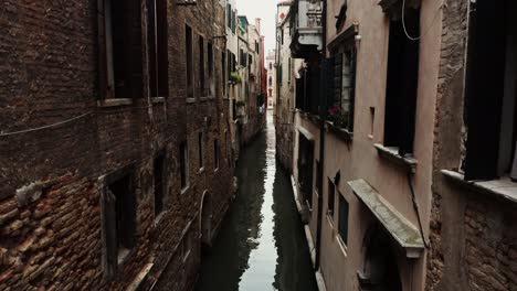 narrow venetian canal with old buildings