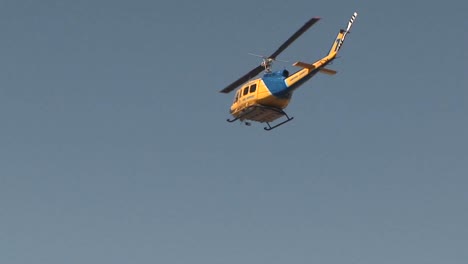 a search and rescue helicopter flies at day