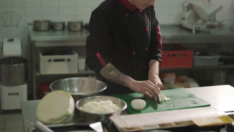 chef chopping cabbage in a restaurant kitchen