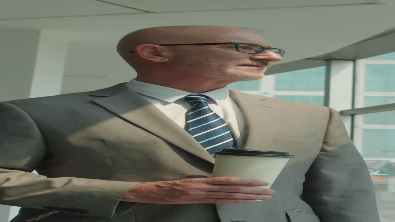 Adult Businessman with Coffee Smiling at Modern Office