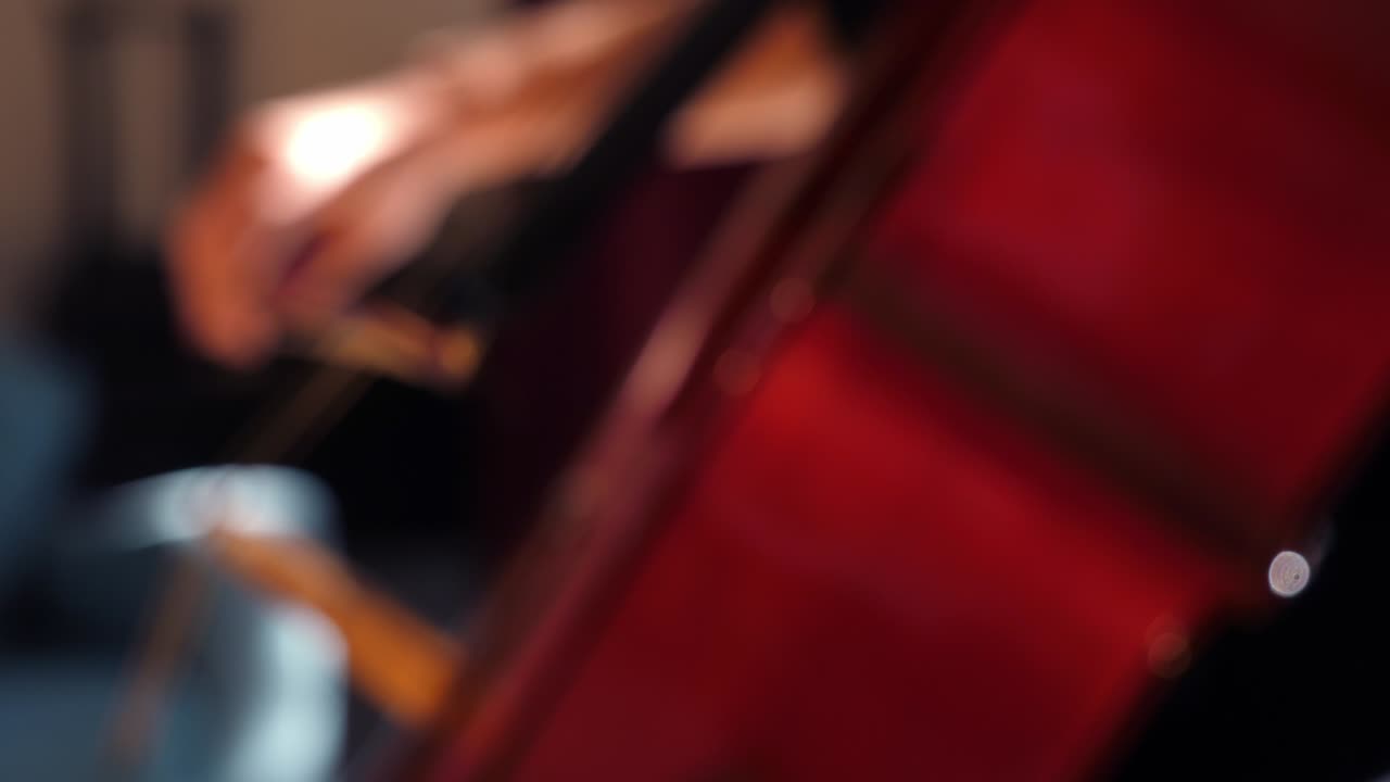 Primo piano di un archetto di violoncello che suona le corde