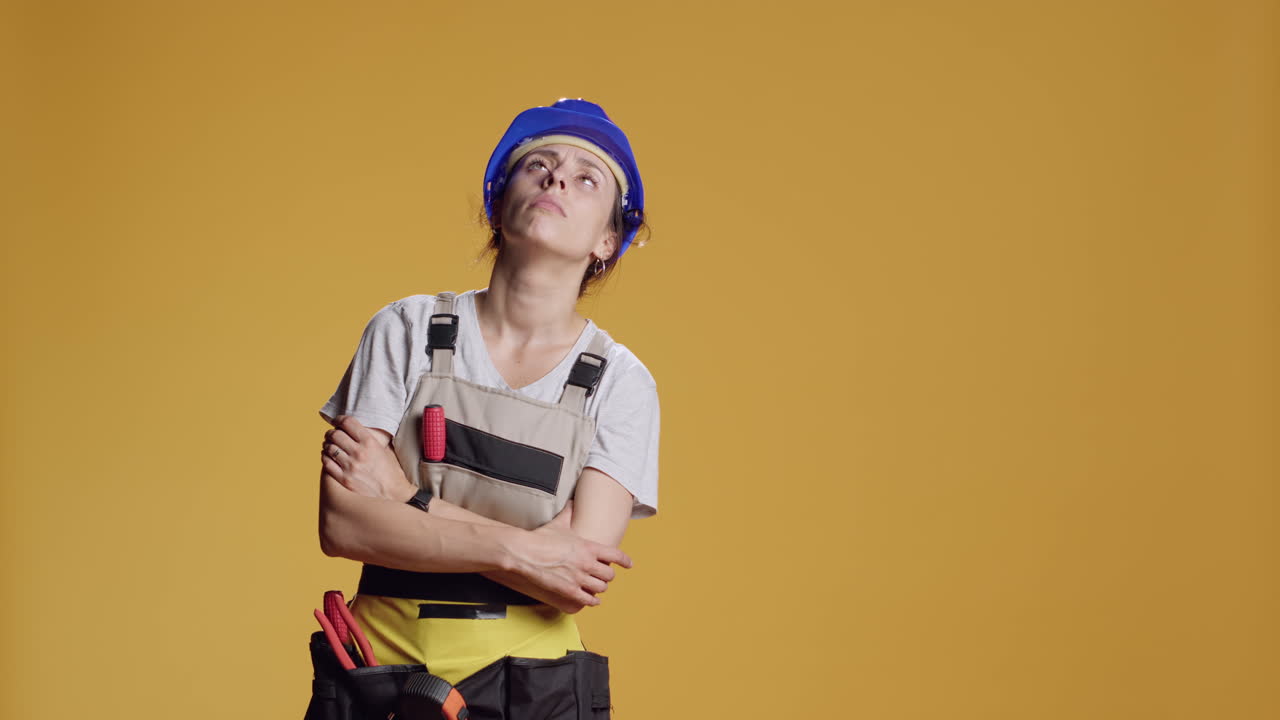 Portrait of light headed contractor being hit in head with hammer