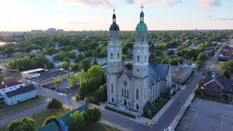 an aerial view of the saint stanislaus b and m roman catholic church spires in buffalo, new york in the light of the setting sun