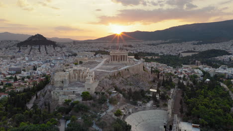 Acropolis of Athens from 5th century BC, Parthenon and Odeon of Herodes Atticus amphitheatre with sunrise background, Athens, Drone shot