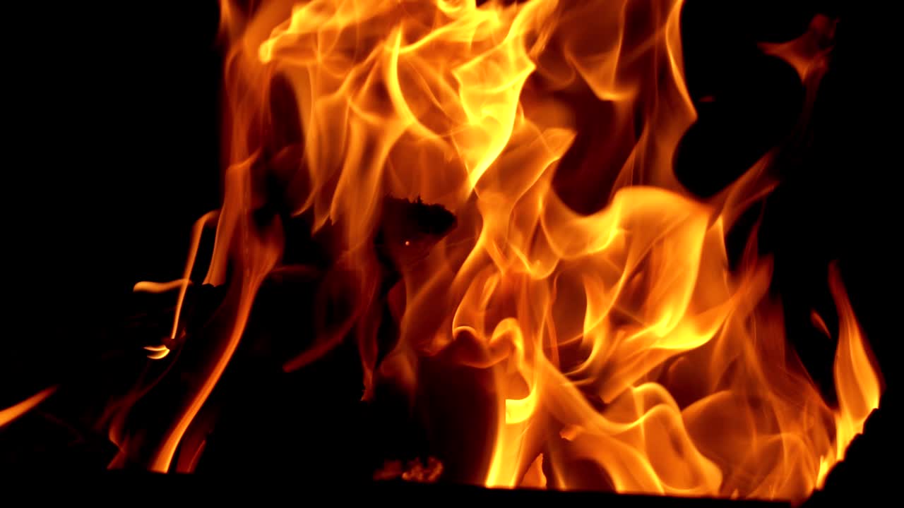 Burning fire in a home fireplace. Flame heats the rural farmhouse. Slow motion