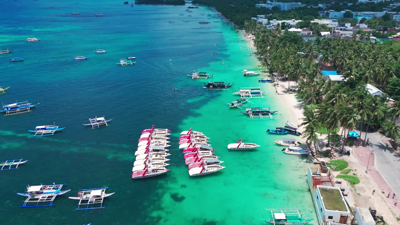 Stunning 4K drone view of Boracay’s White Beach lined with palm trees, turquoise waters, and Filipino outrigger boats—perfect for tourism, travel, and tropical destination media