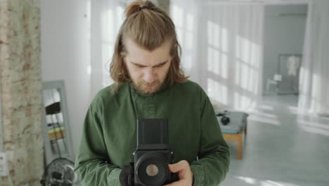 photographer looking at camera and capturing images in studio
