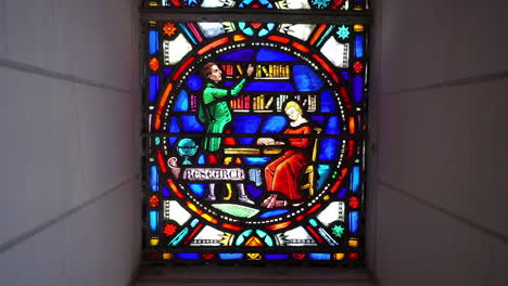 stained glass window depicting the theme of research