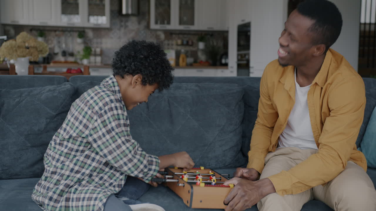 Father and Son Playing Foosball