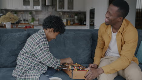 father and son playing foosball