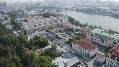 aerial view of a city with a river and park