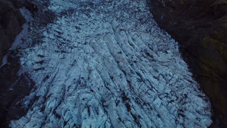 glacier tongue in iceland, south coast with crevasses and ash sediments on top