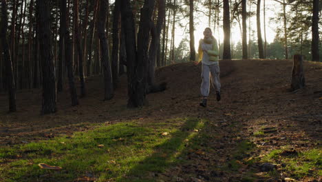 A-teenage-girl-walks-with-a-golden-retriever-in-the-autumn-forest