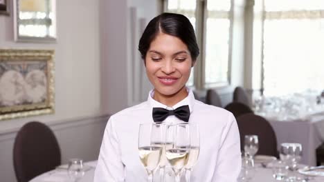 Pretty-waitress-holding-a-tray-of-champagne