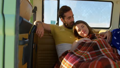 Young-romantic-couple-relaxing-in-van-4k