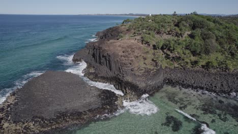 sea waves crashing on volcanic rock formation at the fingal head causeway