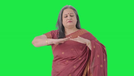 Happy-Indian-old-woman-doing-breathe-in-breathe-out-exercise-Green-screen