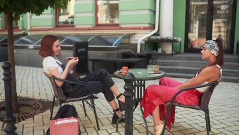 two women enjoying coffee in an outdoor cafe