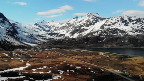 Scenic-aerial-of-mountains-covered-in-snow-on-a-sunny-day