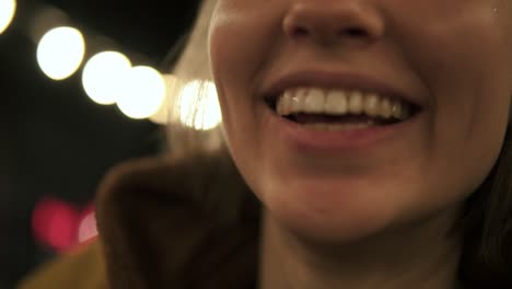 group of young friends sitting by the fire on the beach, grilling sausages and playing guitar. slow motion shot