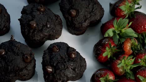 spinning shot of chocolate beets muffins and chocolate covered strawberries for valentines day candy heart love