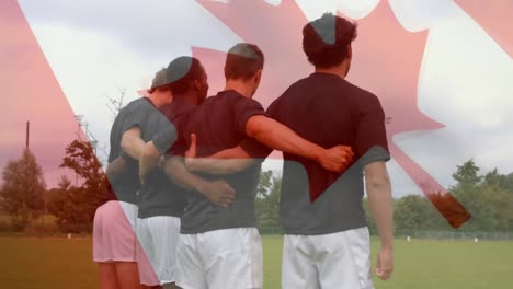 rugby team standing on the field with a canadian flag