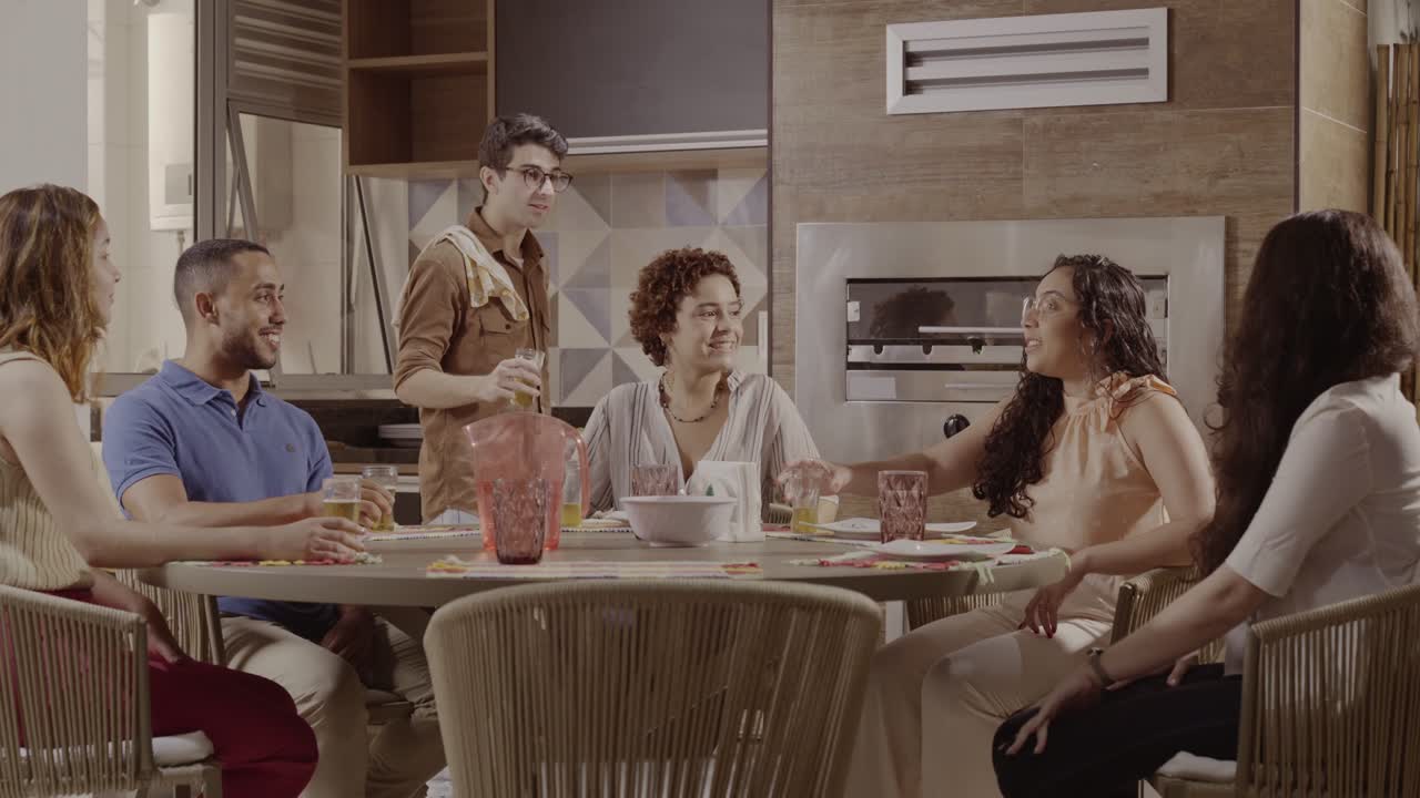 Friends Cheering and Celebrating with Drinks at an Indoor Gathering