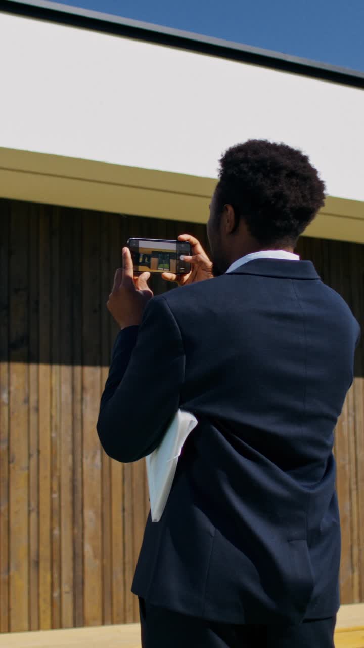 Real Estate Agent Taking Pictures of a Modern House